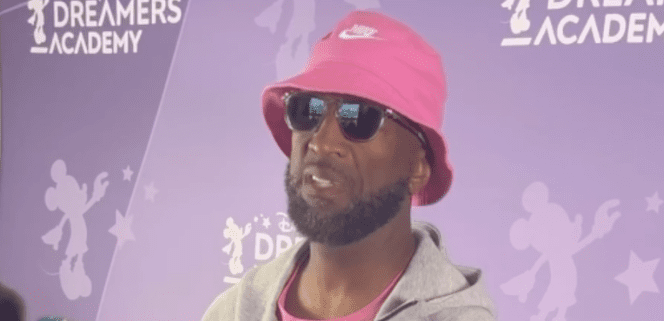 Man in pink hat at Dreamers Academy event.